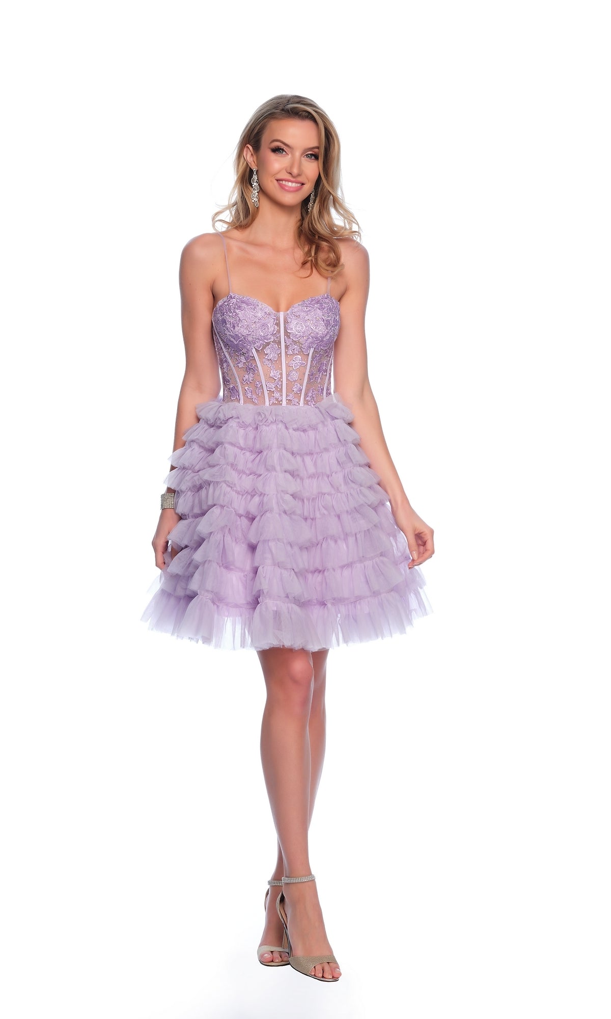 A woman stands smiling against a white background wearing the Dave and Johnny Ruffled Purple Hoco Dress 11766, which features a short ruffled skirt, corset-style bodice, and spaghetti straps.